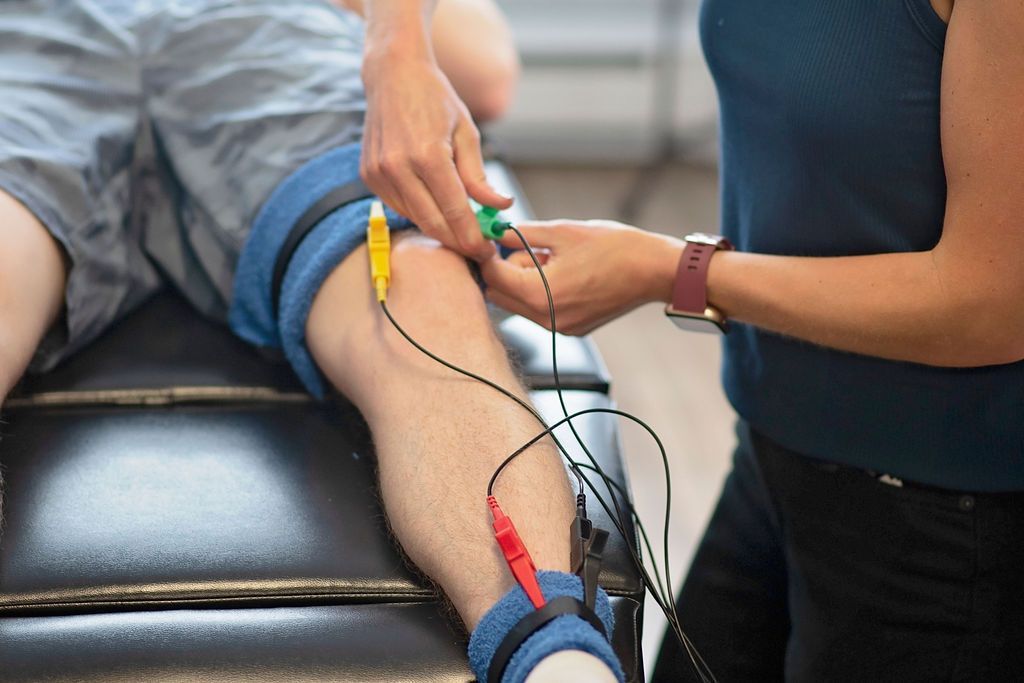 a person is getting electrodes on their leg