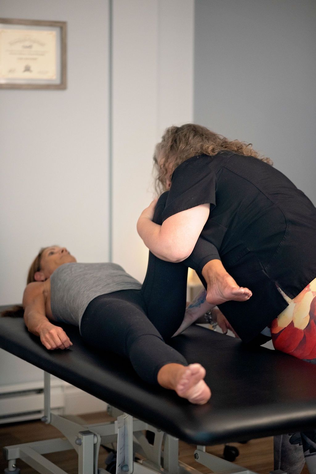 a woman is laying on a table with her legs crossed