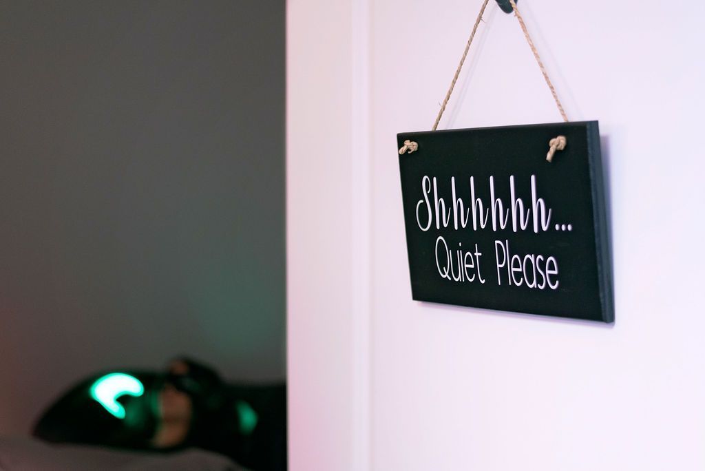 Small chalkboard sign on a wall reading 