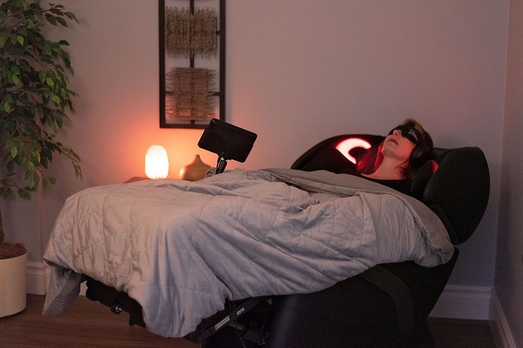 A person is laying in a recliner in a bedroom.
