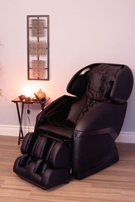 a black massage chair is sitting in a room