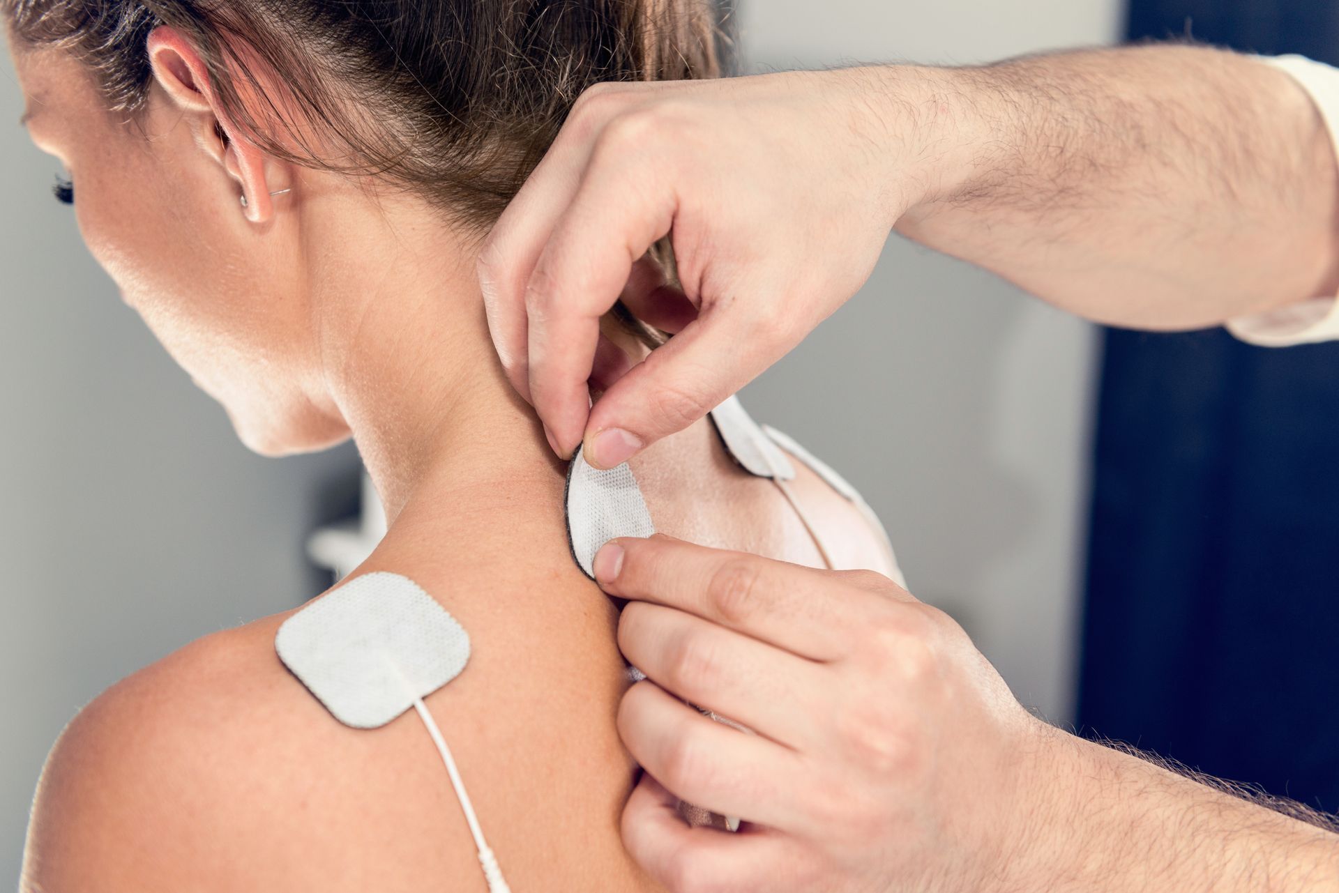 a woman is getting an electrical stimulation on her neck