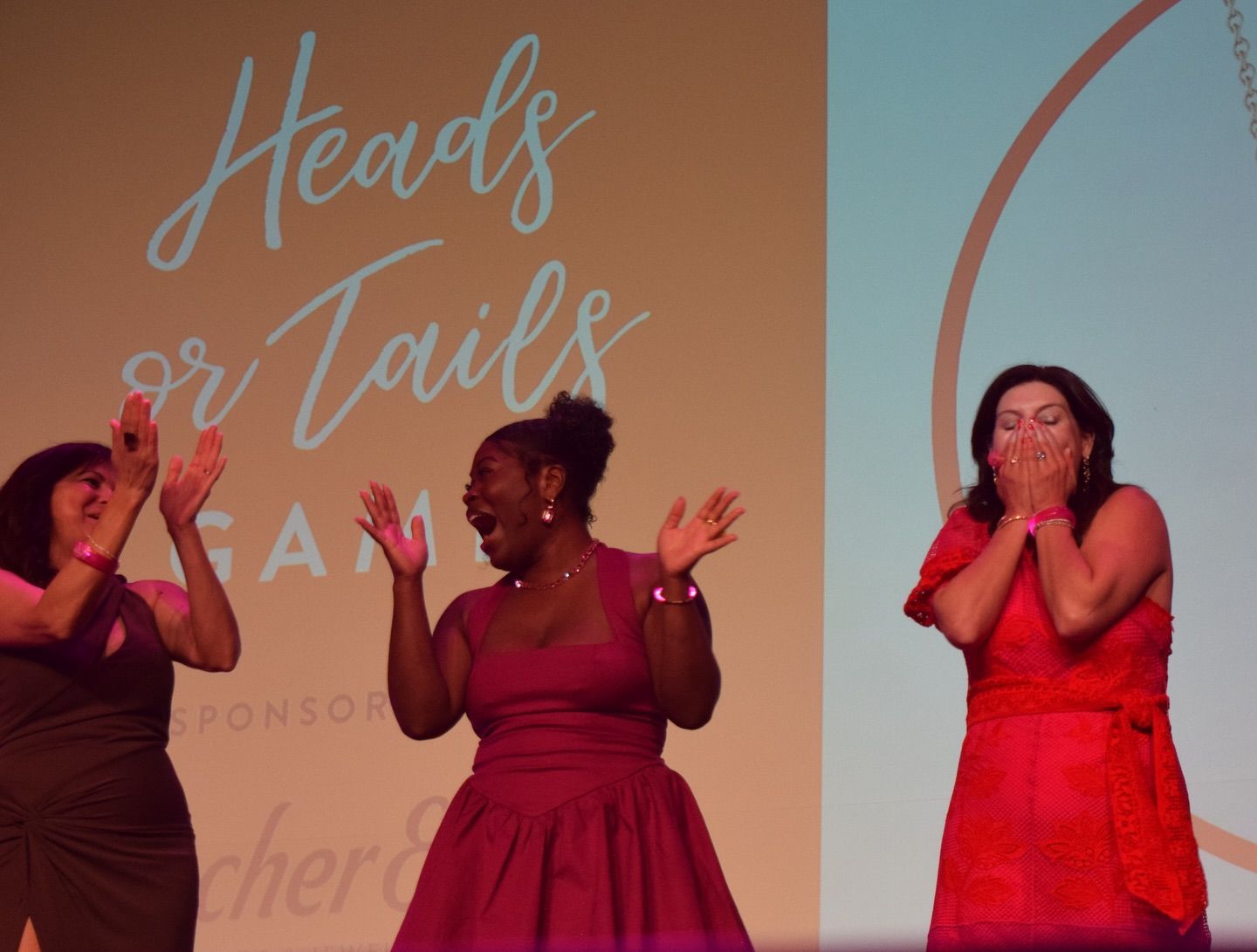 A group of women in colorful dresses are dancing in a room.