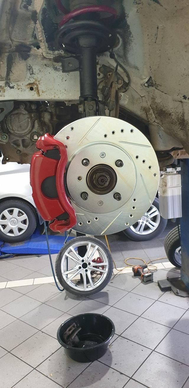 A Close up Of a Brake Disc on A Car in A Garage — TGR Automotive–Honda Specialist in  Lismore, NSW