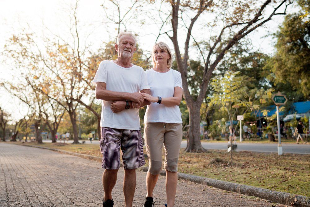 Old Couple Walking On Park — Salisbury, MD — Robert W Nock Insurance
