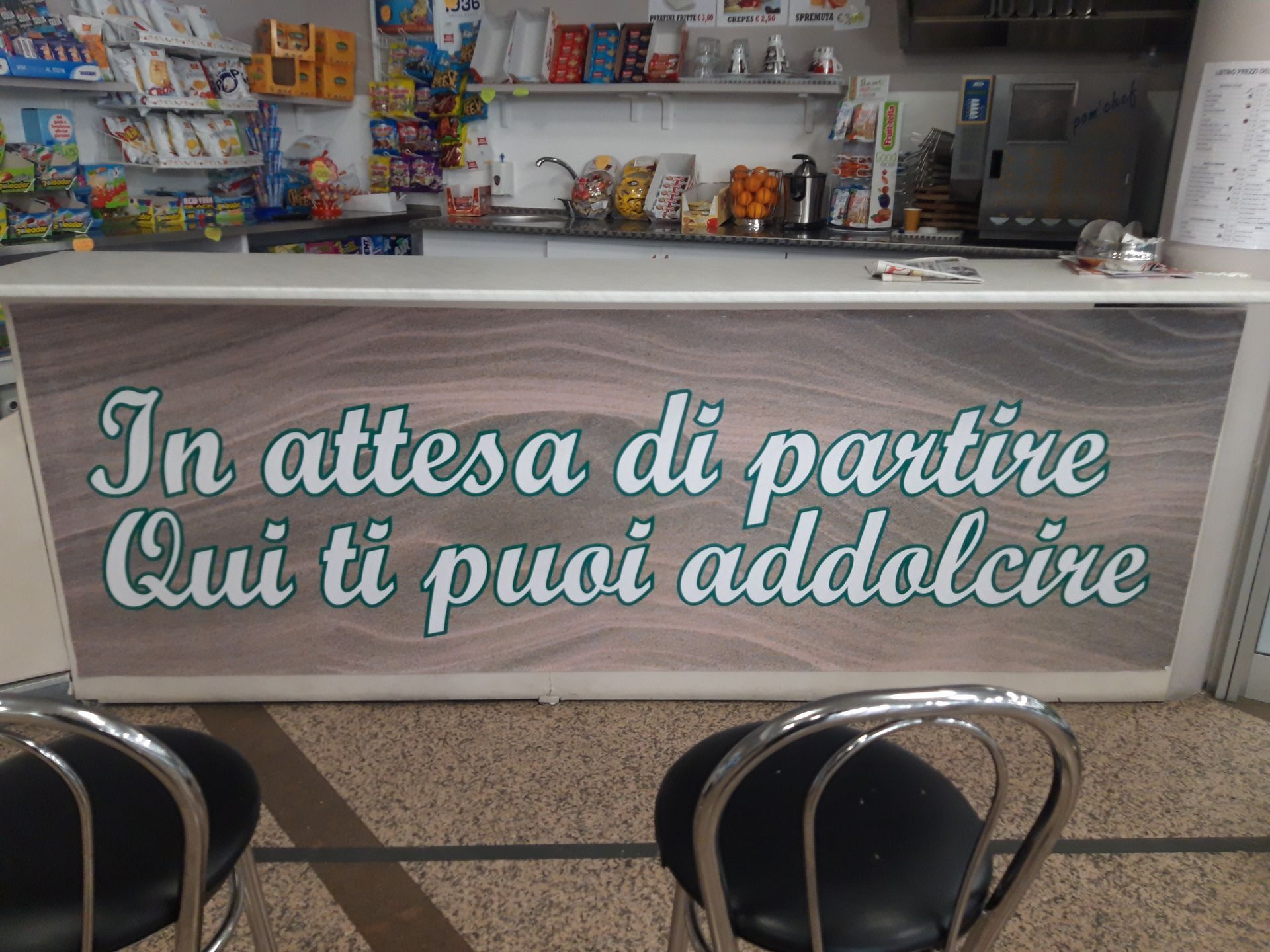 A sign on a counter says in attesa di partire qui ti puoi addolcire