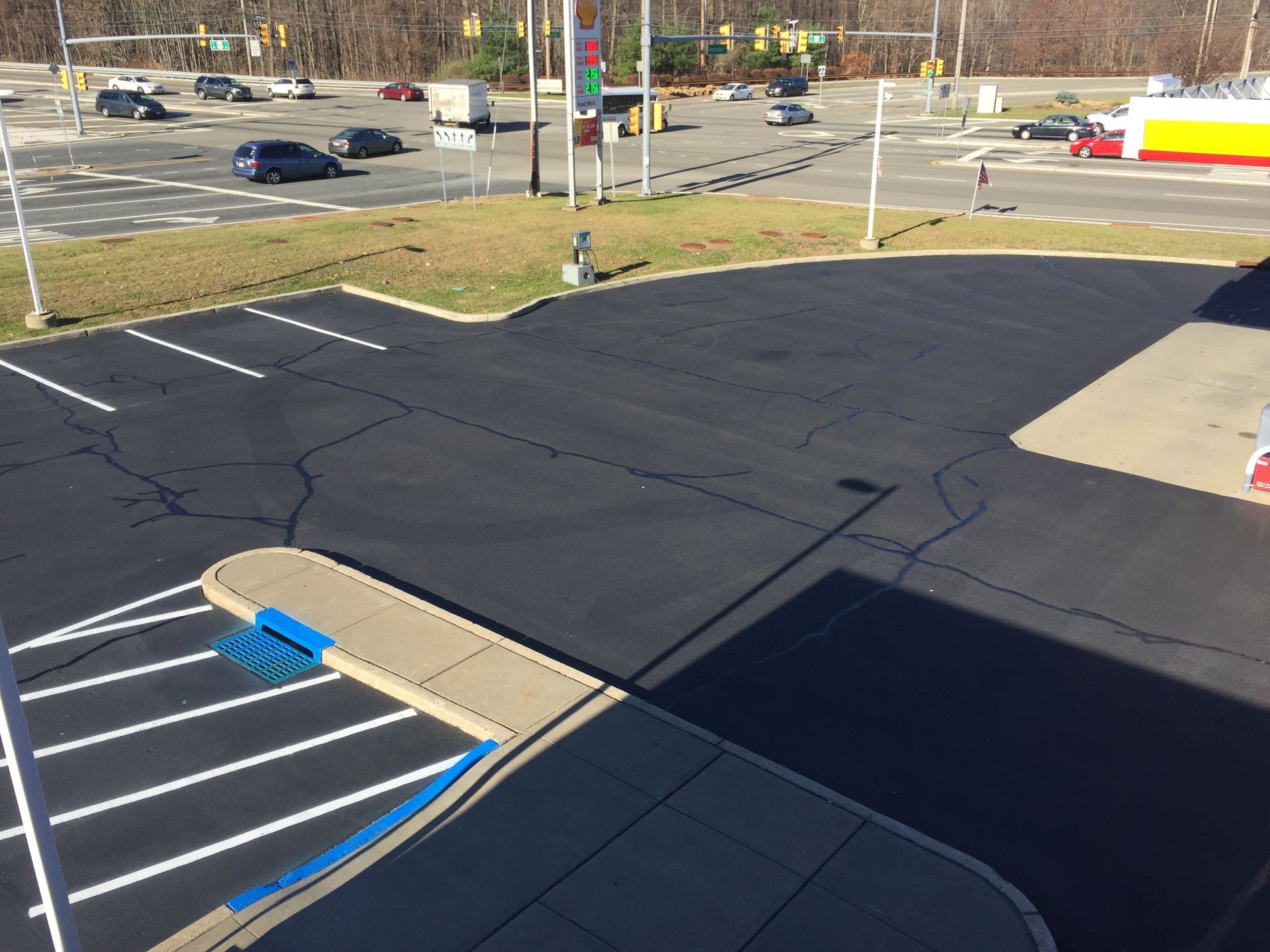 An aerial view of a parking lot next to a gas station