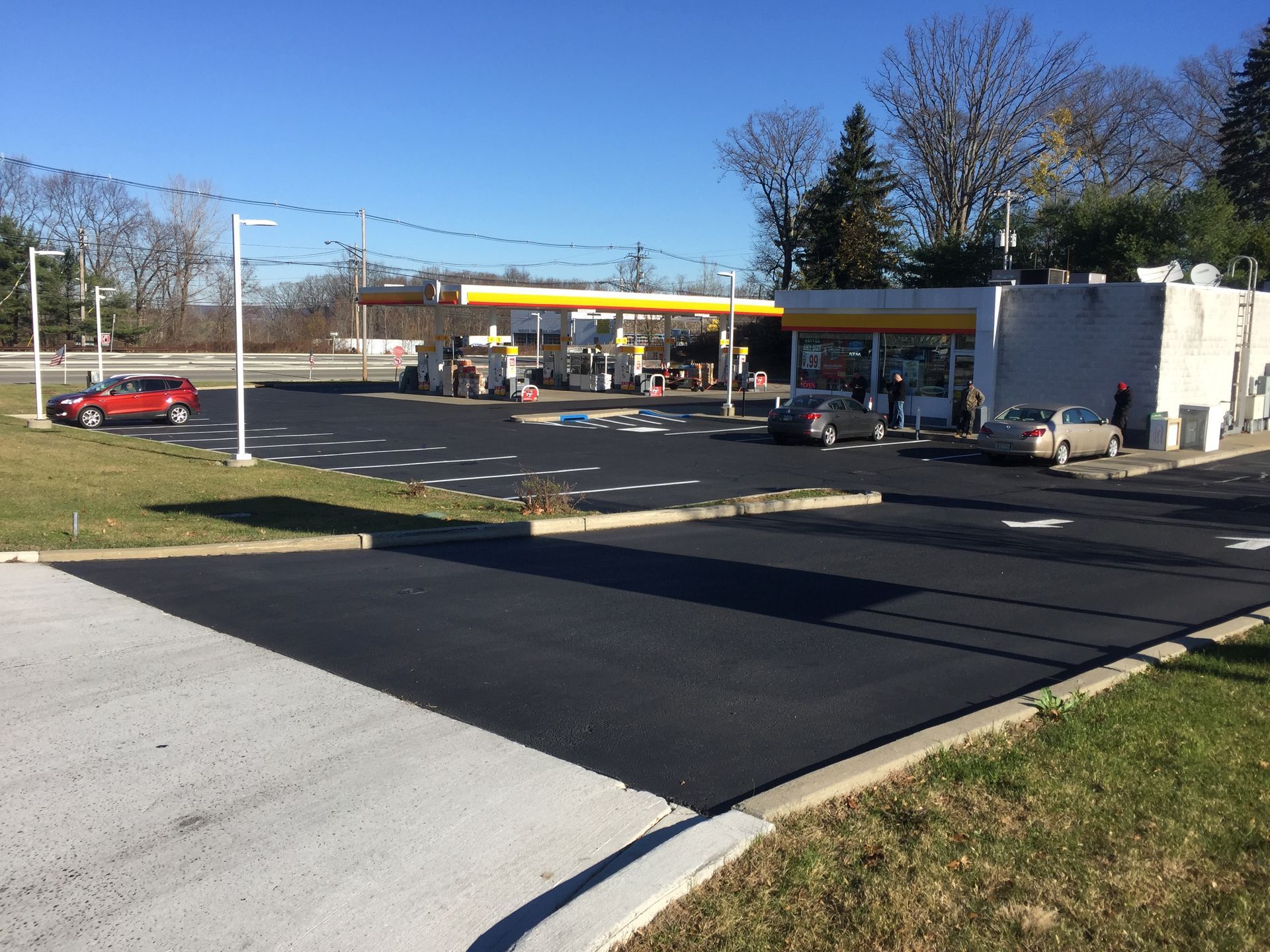 A gas station with cars parked in front of it