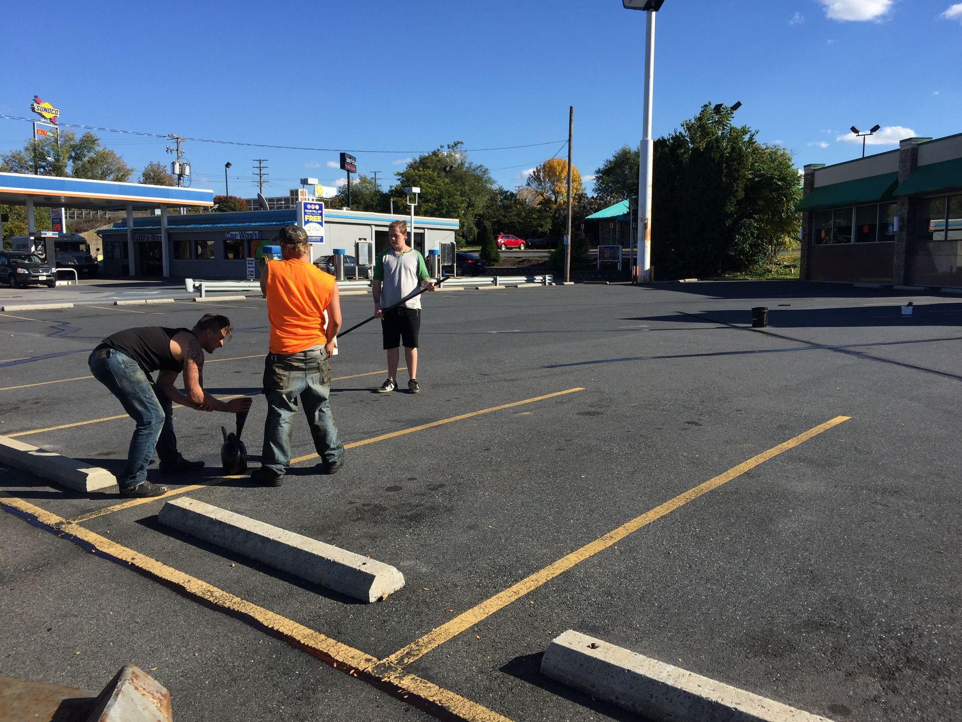 A group of people are working in a parking lot