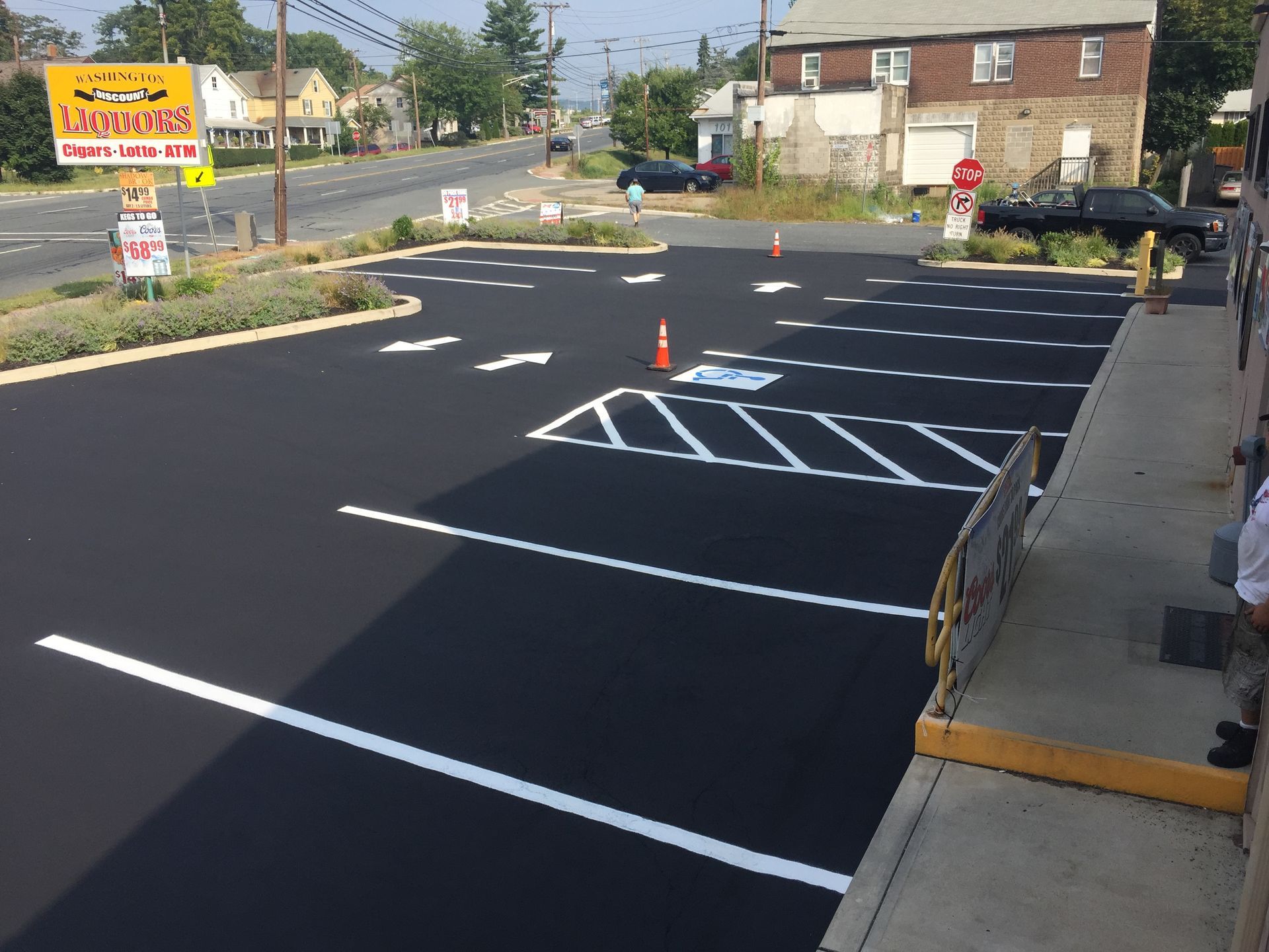 A parking lot with a yellow sign that says ' hamburger ' on it