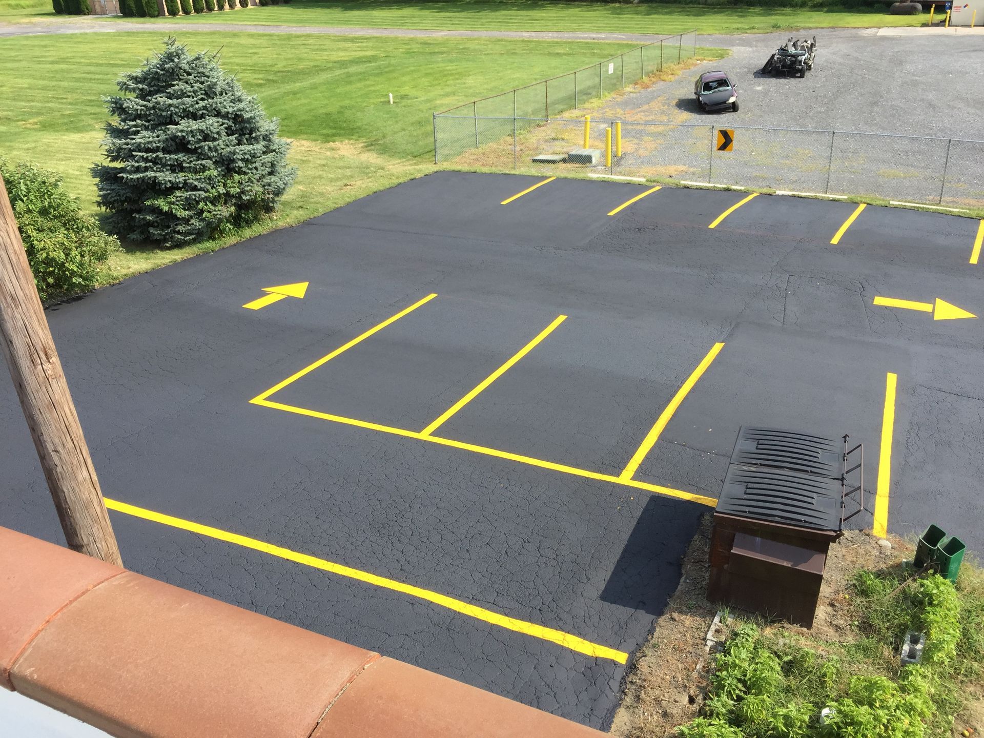 A parking lot with yellow lines and an arrow pointing to the right