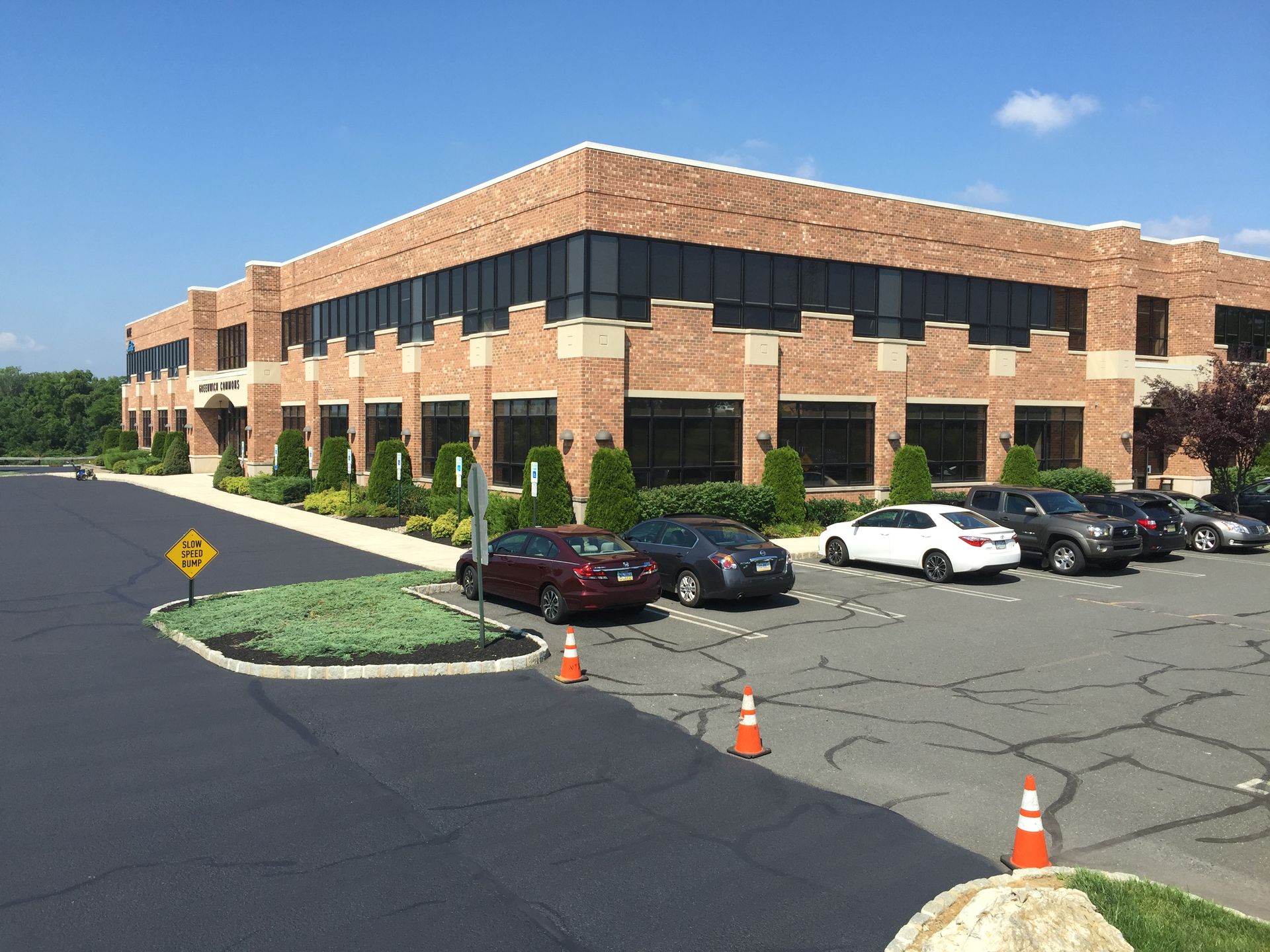 A large brick building with cars parked in front of it