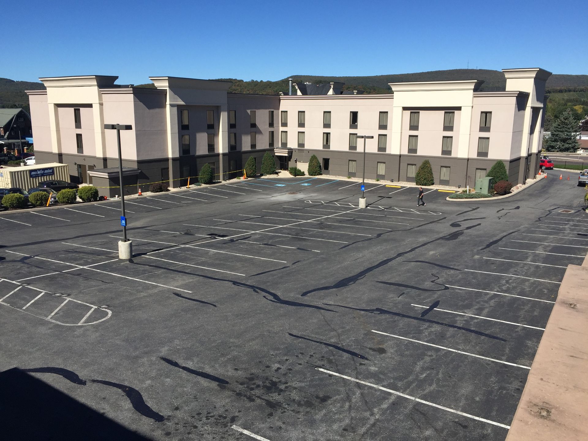 An empty parking lot in front of a large building
