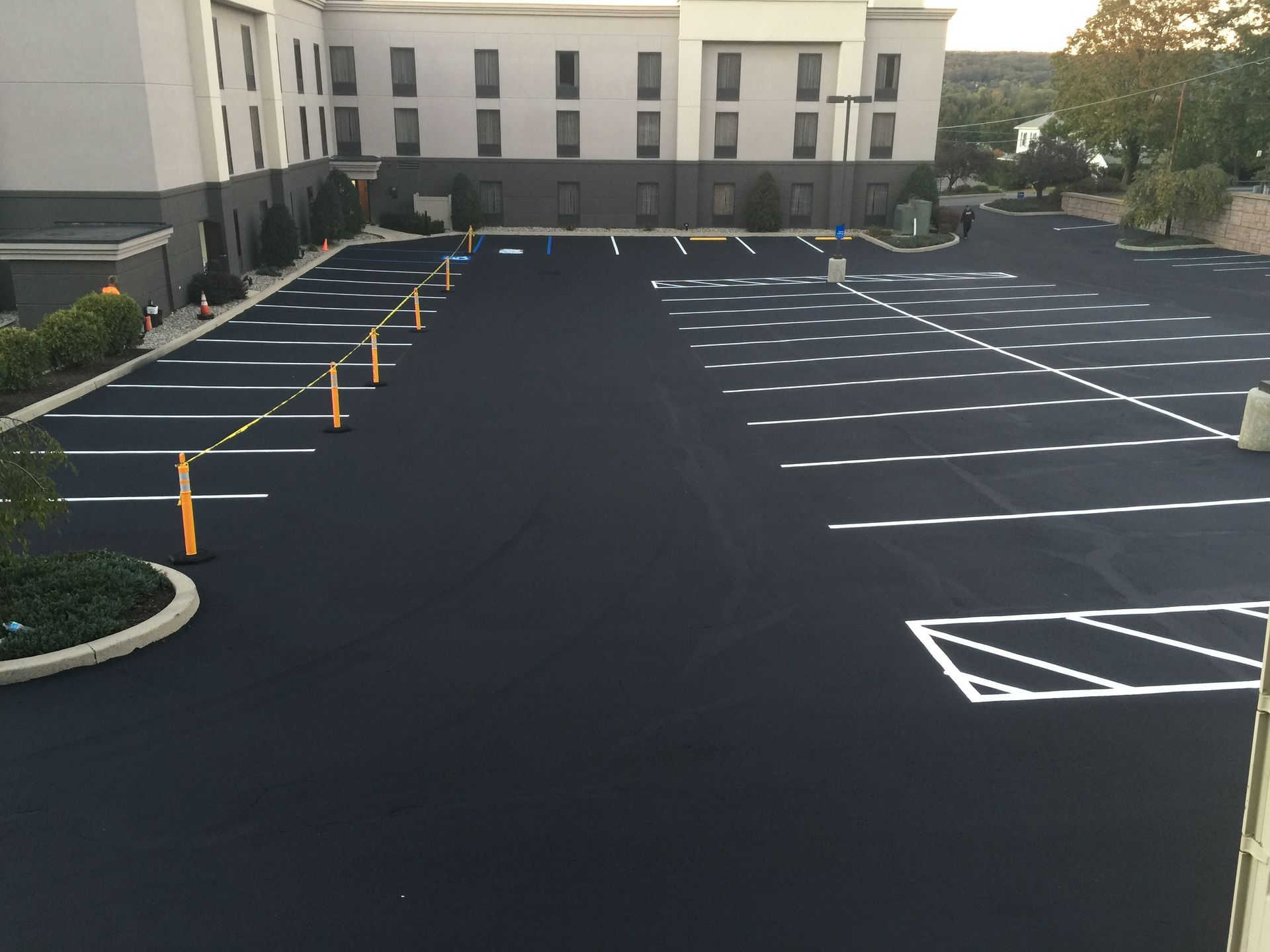 A large parking lot with a building in the background.