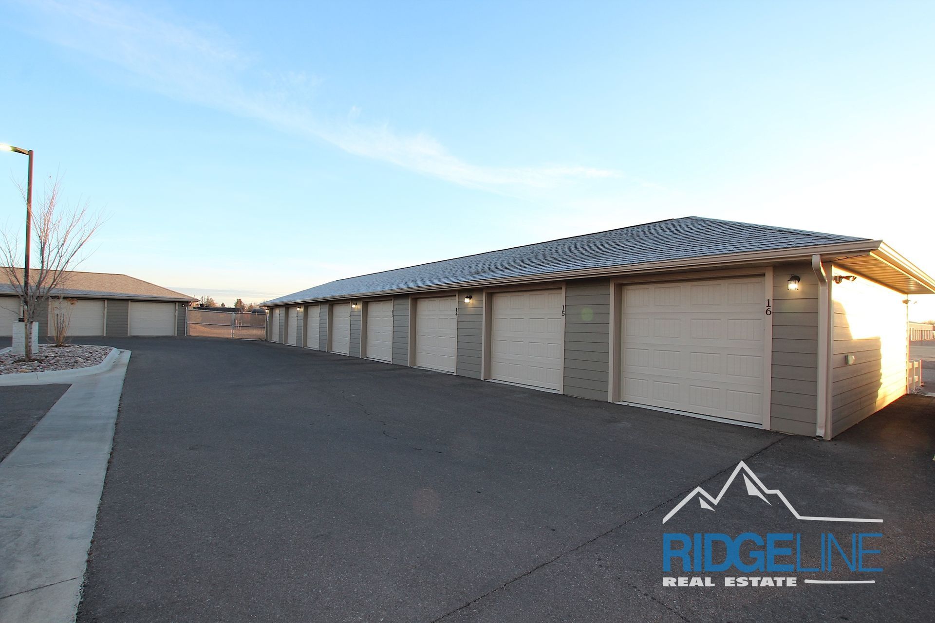 A row of garages with ridgeline real estate written on the side