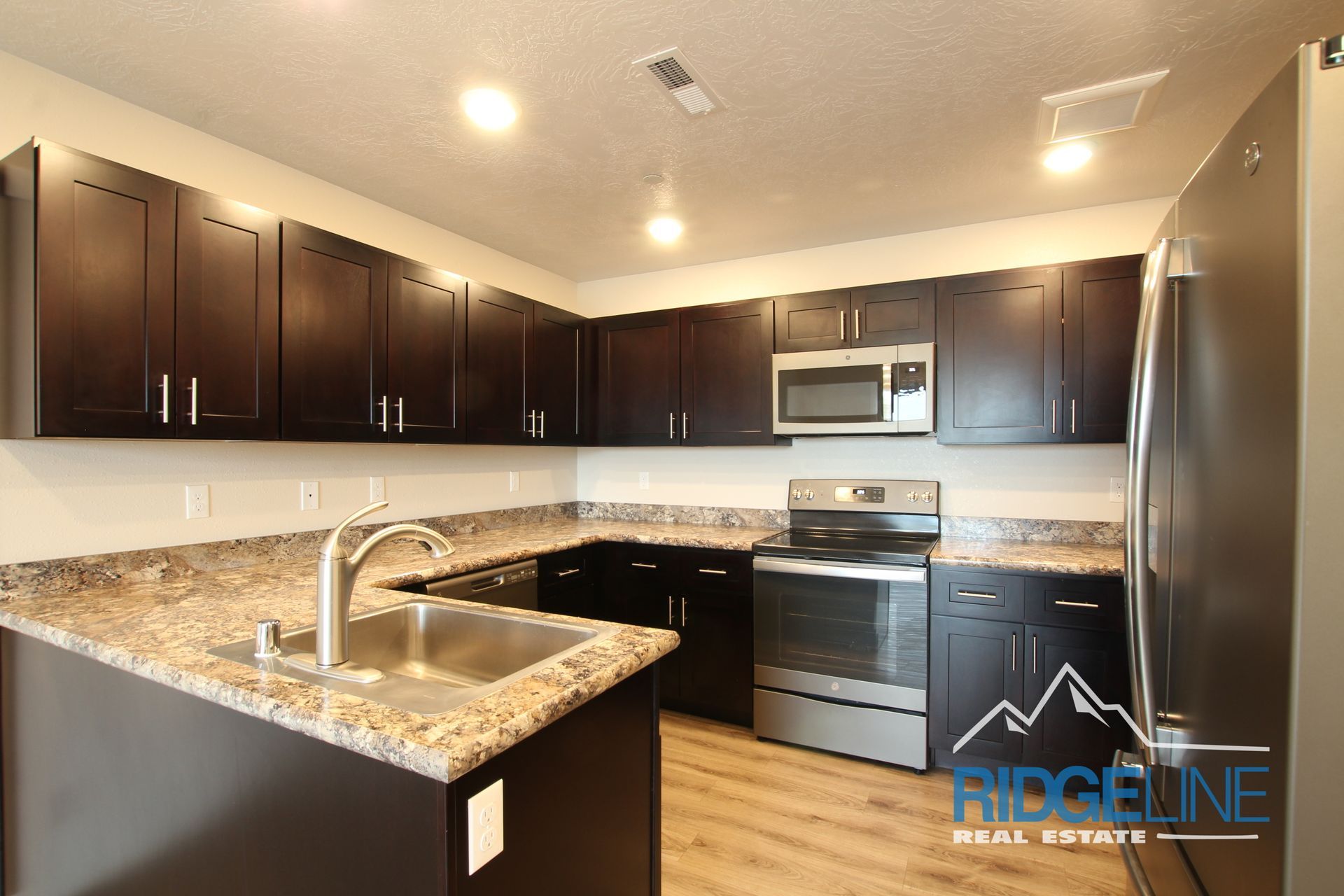 A kitchen with stainless steel appliances and granite counter tops