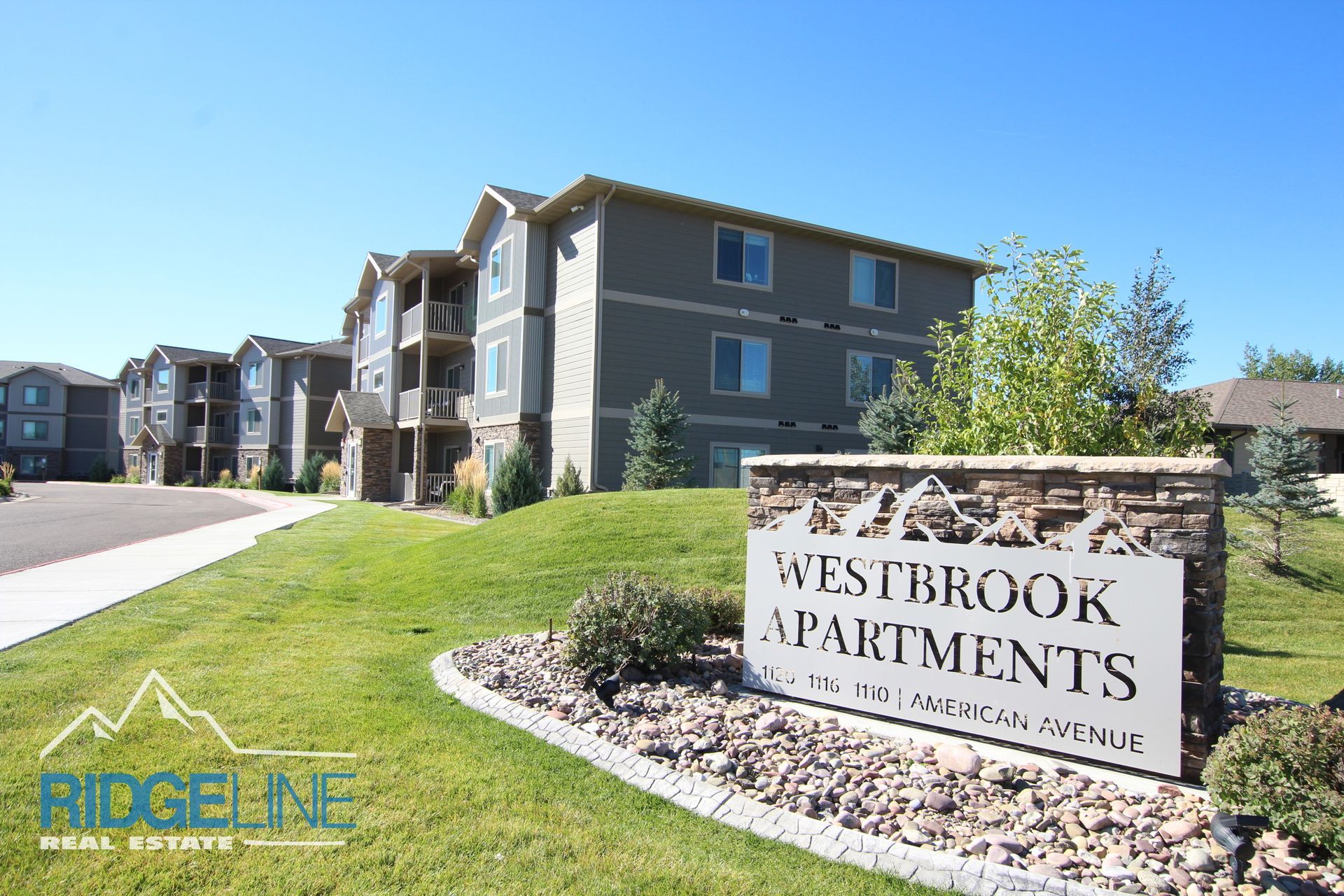A sign for westbrook apartments is in front of a building