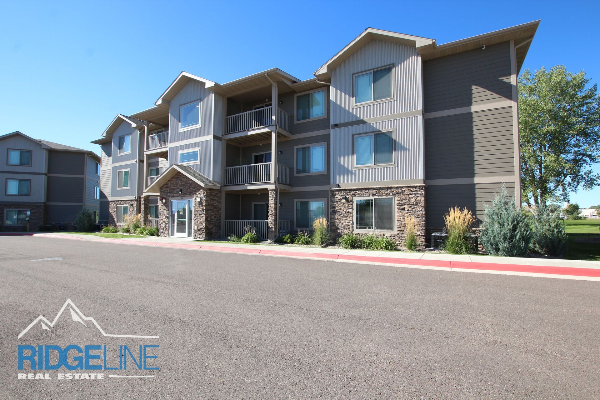 A large apartment building is for sale by ridgeline real estate