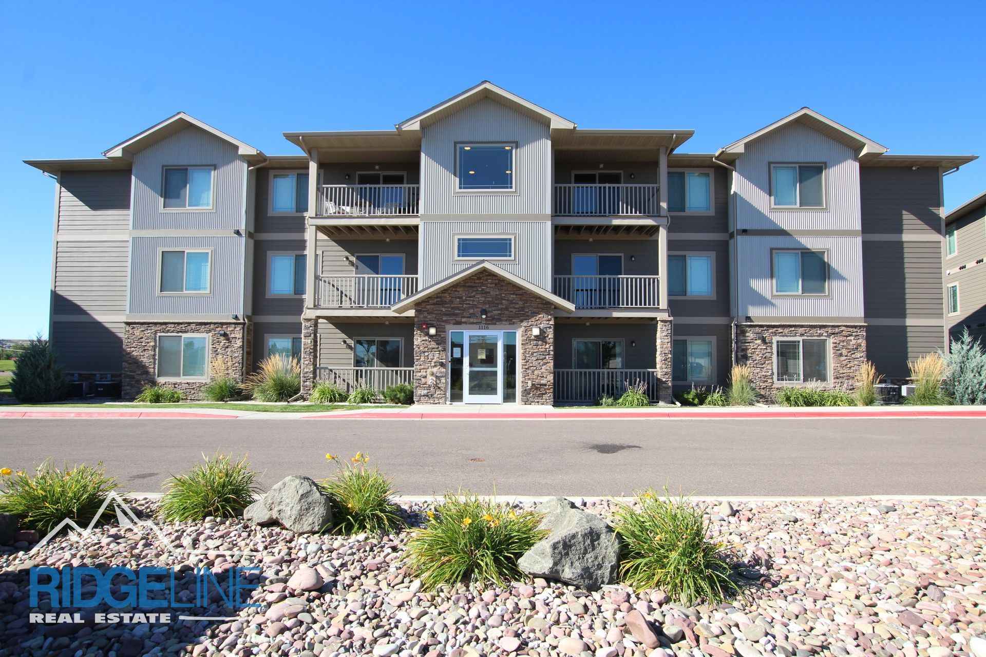 A large apartment building with a sign that says riegelein real estate
