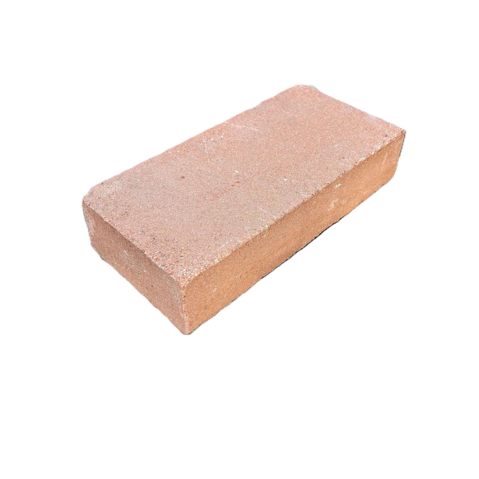 A close up of a brick floor with a herringbone pattern.