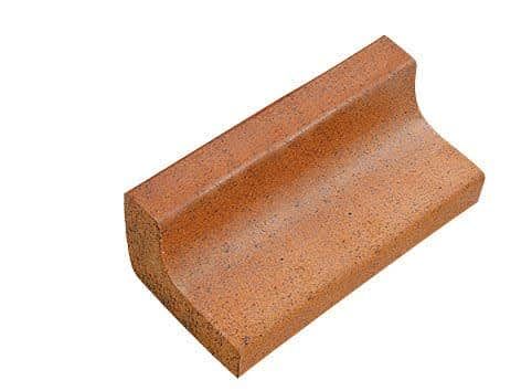 A brown brick is sitting on a white surface.