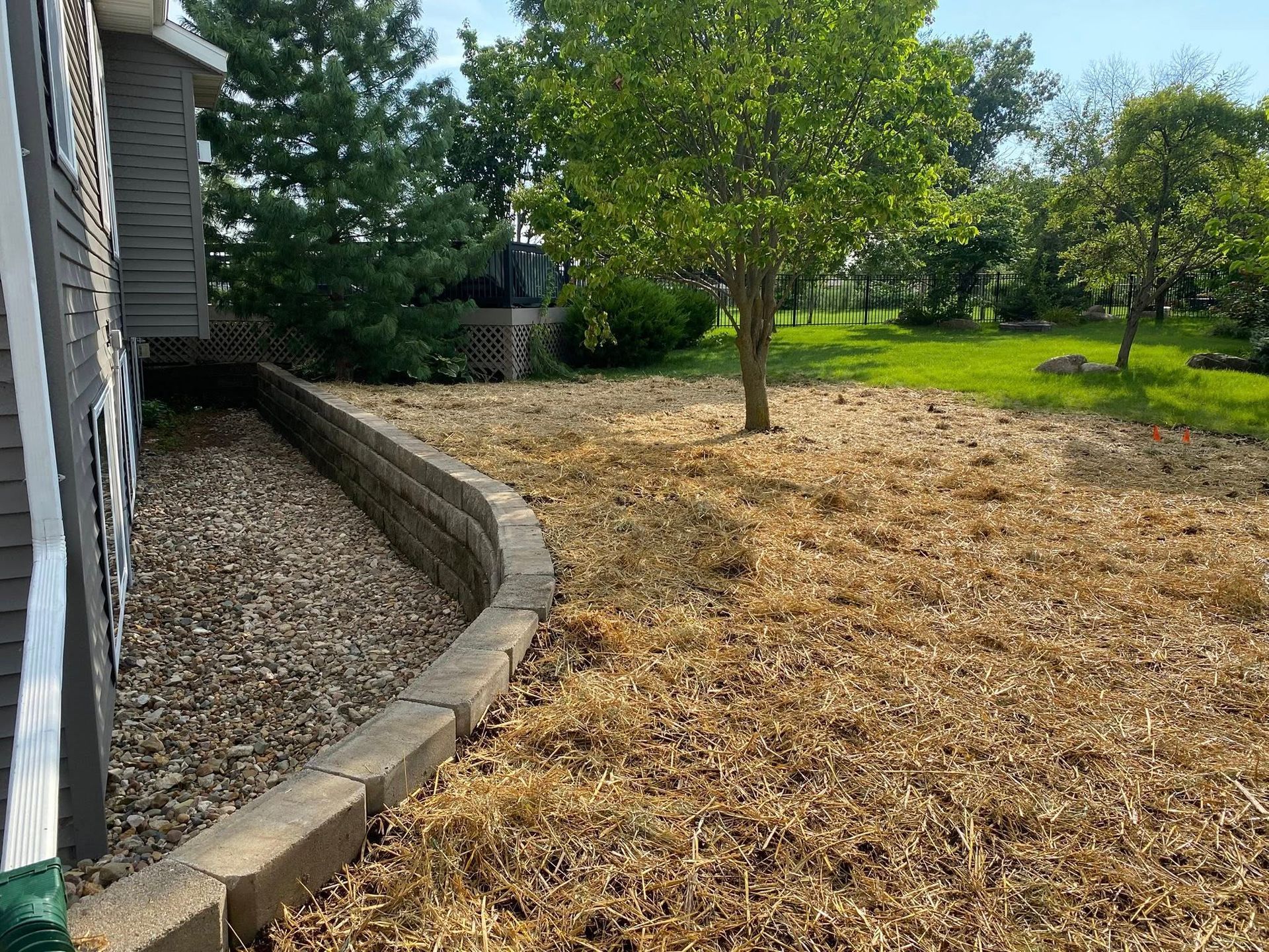 A house with a lot of mulch in front of it.