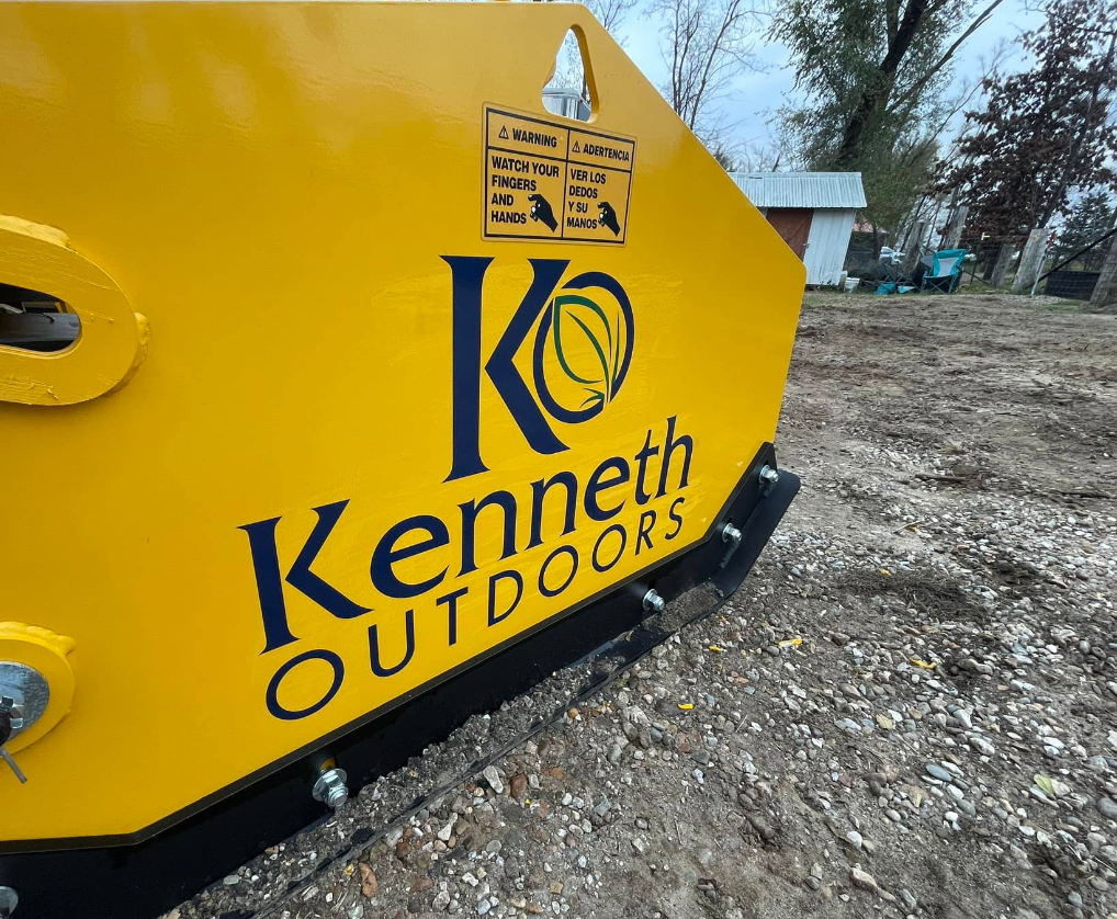 A yellow sign that says kenneth outdoors on it