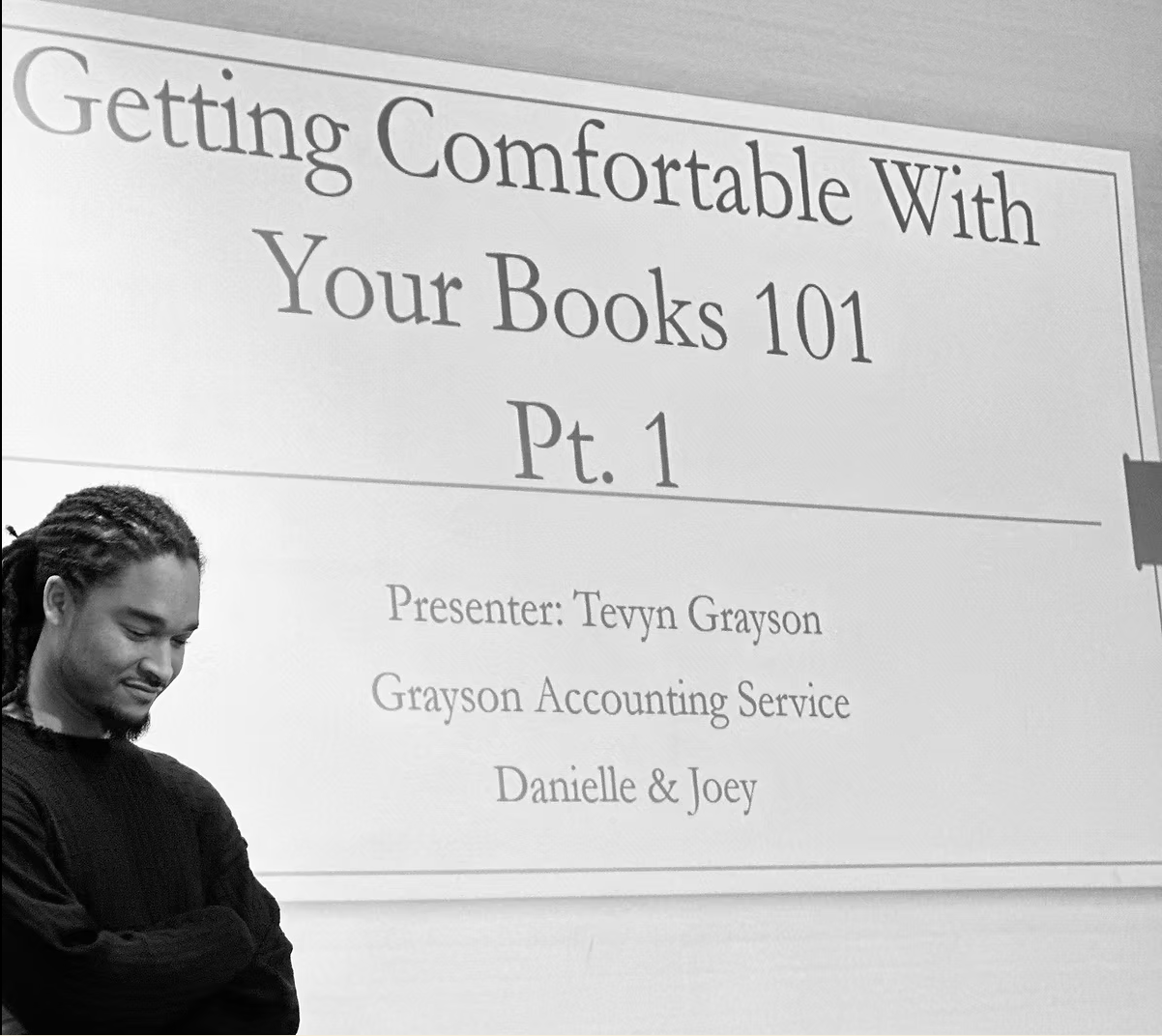 A man stands in front of a sign that says getting comfortable with your books 101 pt. 1
