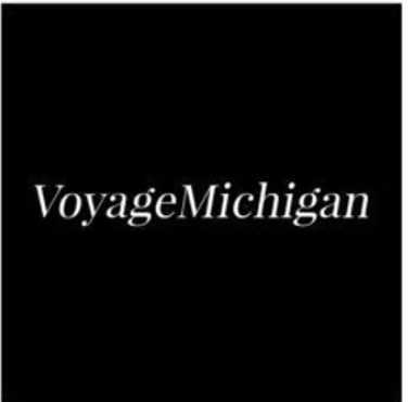 The logo for voyage michigan is on a black background.