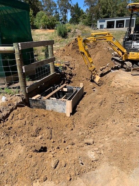 Hands connecting tubing to an outdoor air conditioner unit.