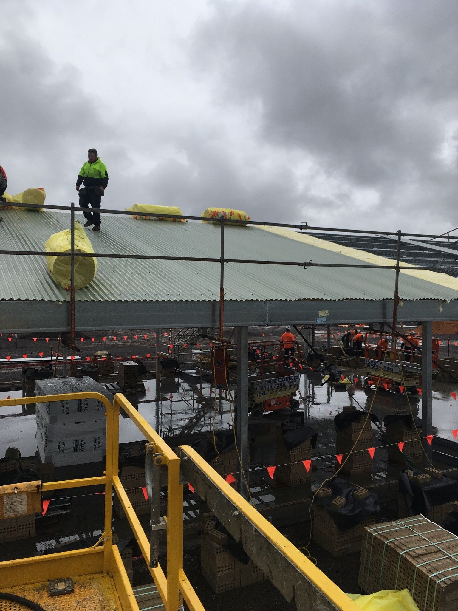 Green corrugated roof with tools, open hatch, and container. Forest in the background.