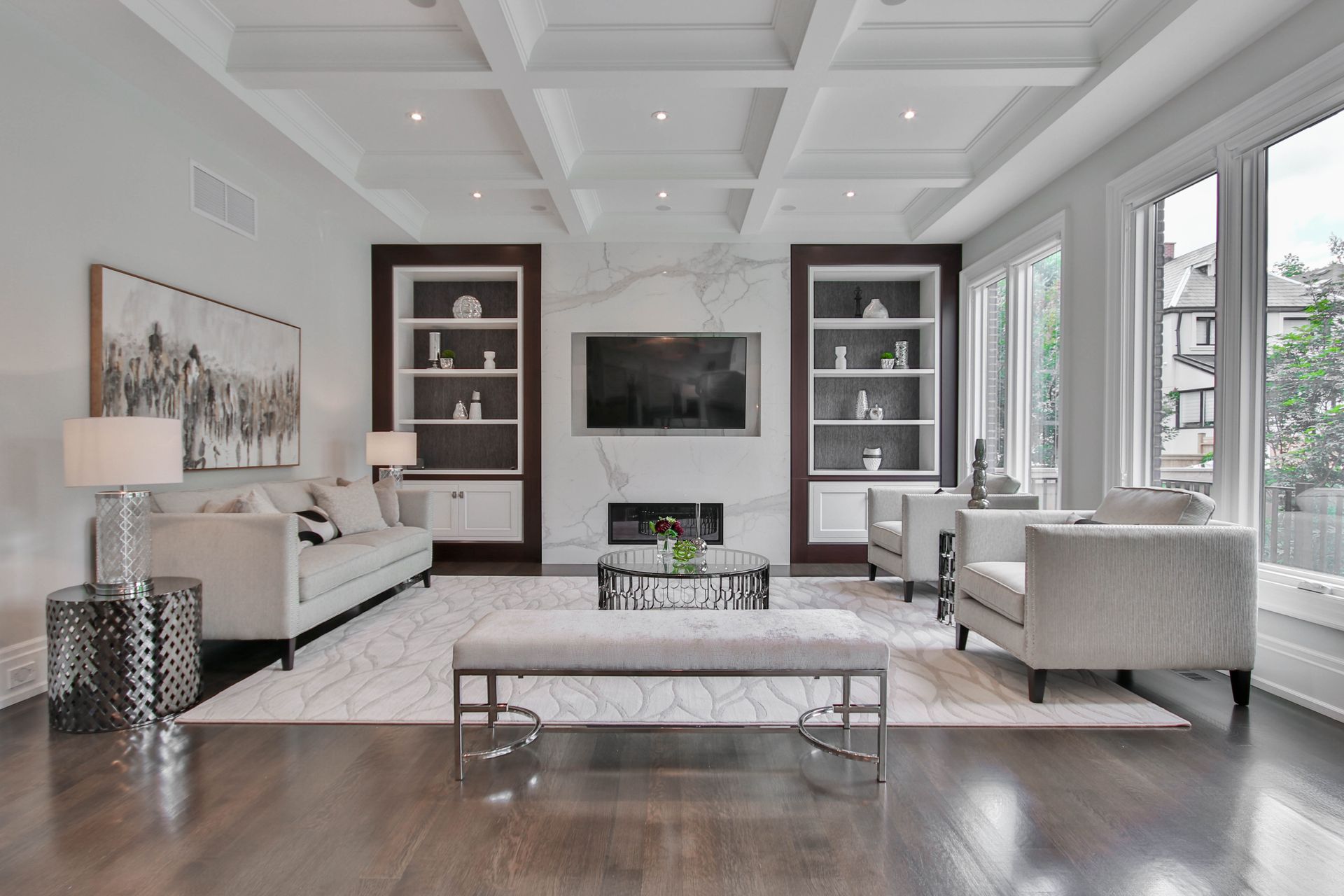 A living room with a couch , chairs , coffee table and television.