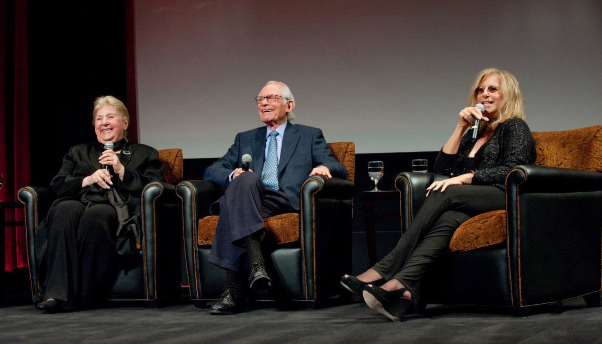 The Bergmans and Streisand on stage at the MPAA event.