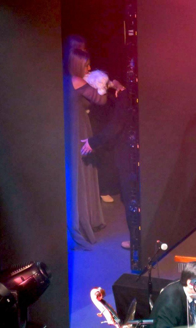 Streisand holding her dog Sammie just offstage at Brooklyn's Barclays Center. Photo by: Joe Naughton