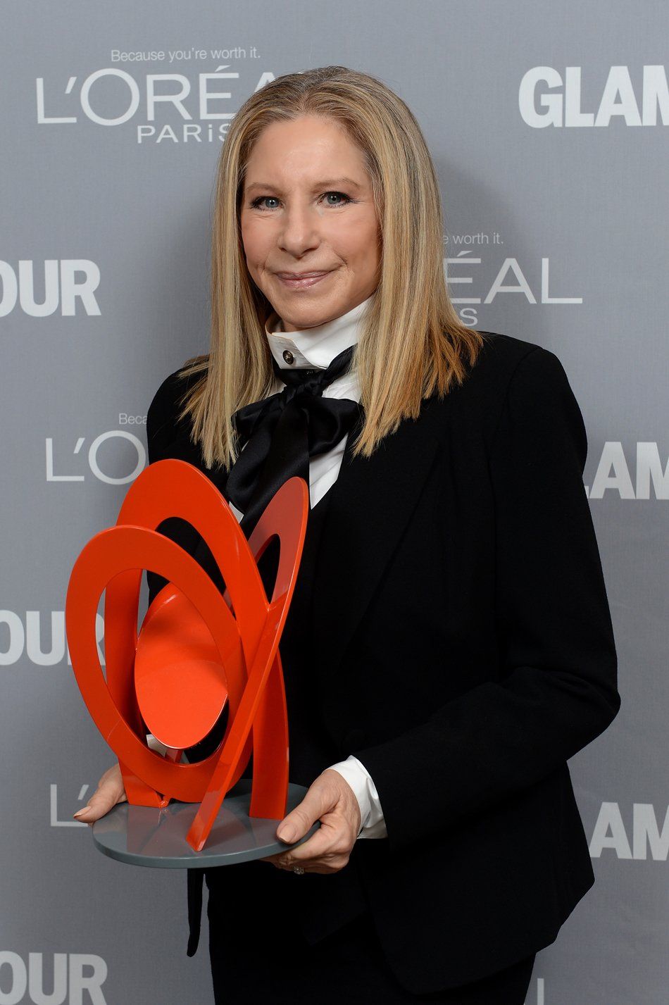 Streisand holds the Glamour Magazine award, 2013.