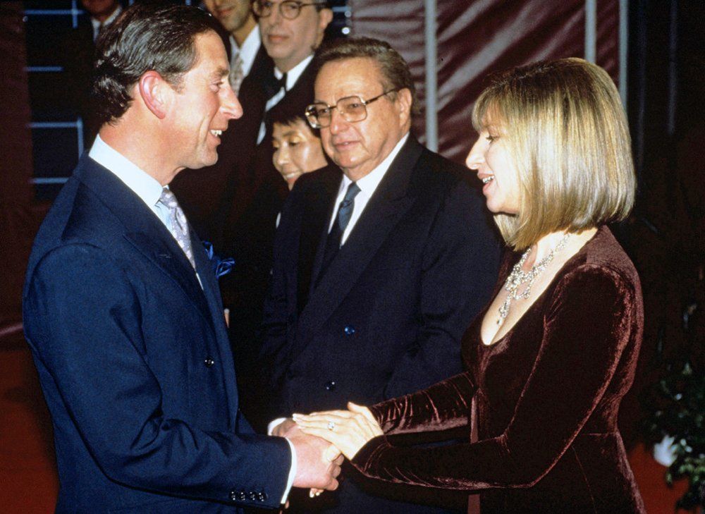 Prince Charles shakes Barbra Streisand's hand.