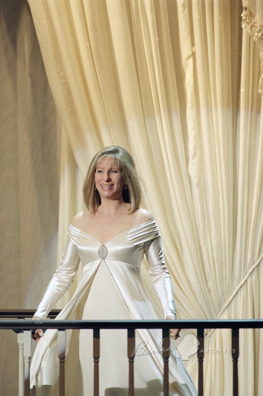 Barbra Streisand greets the audience in a cream gown at the beginning of her concert series in New York at Madison Square Garden Monday, June 20, 1994.