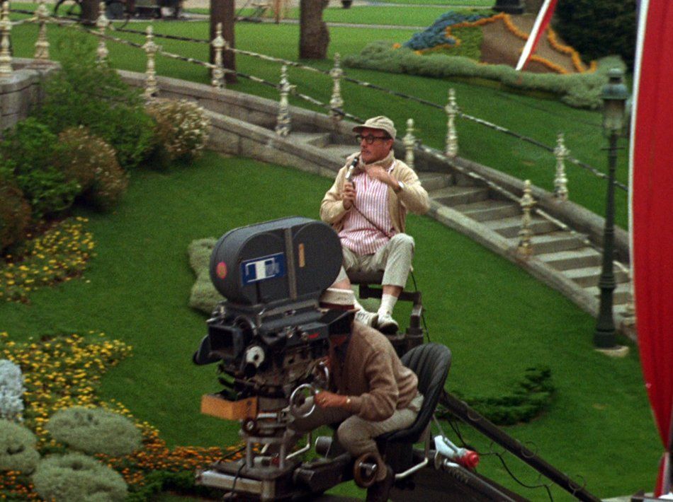 Gene Kelly on camera platform filming the parade.