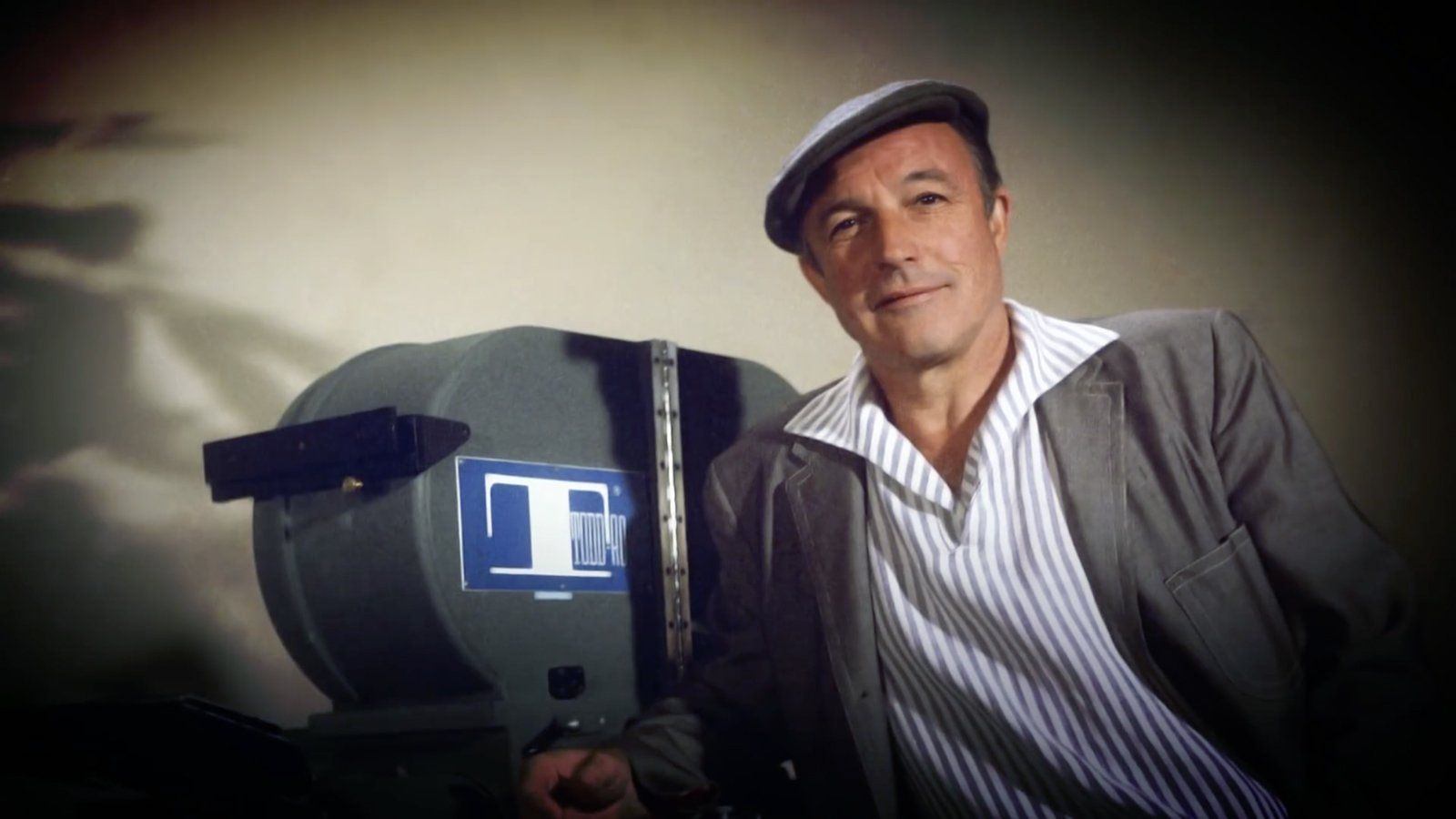 Gene Kelly poses with a large format Todd-AO Camera