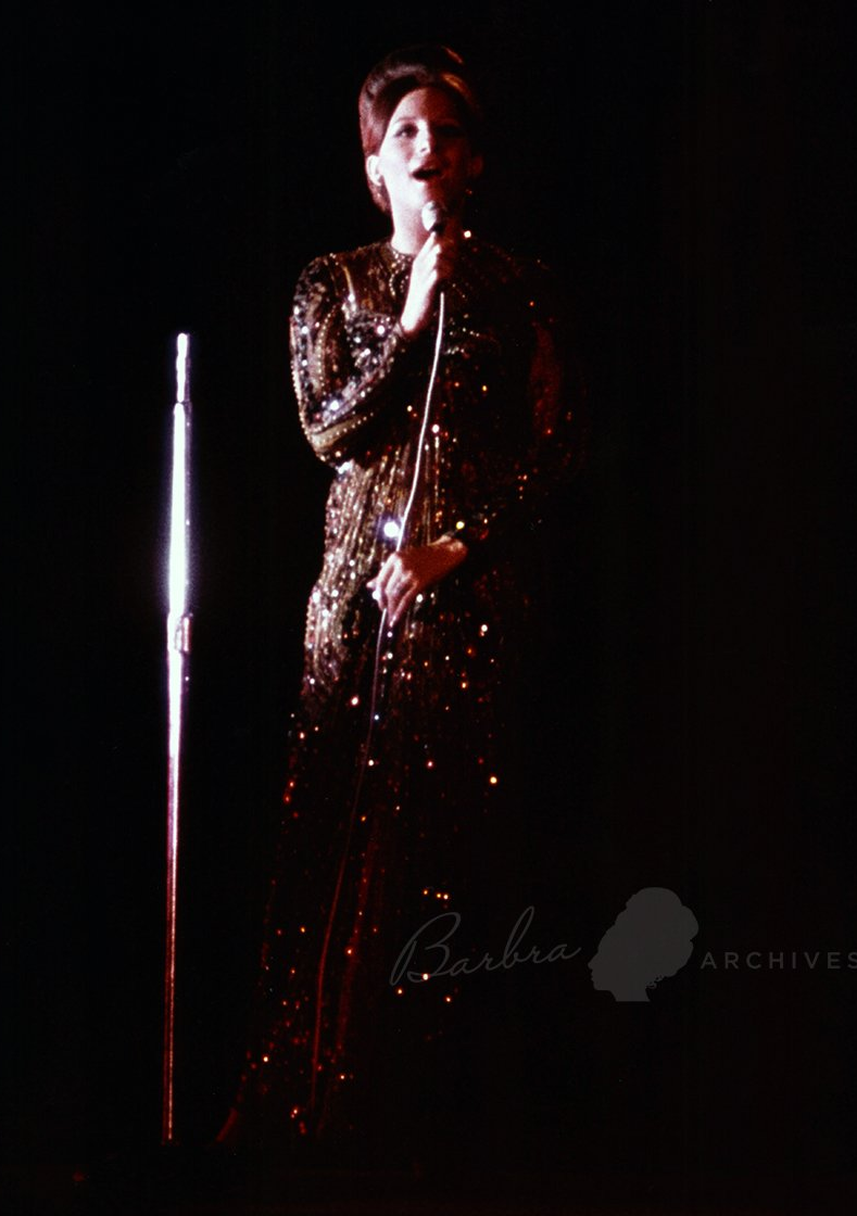 Barbra Streisand in Galanos gown, singing at the American Embassy in London
