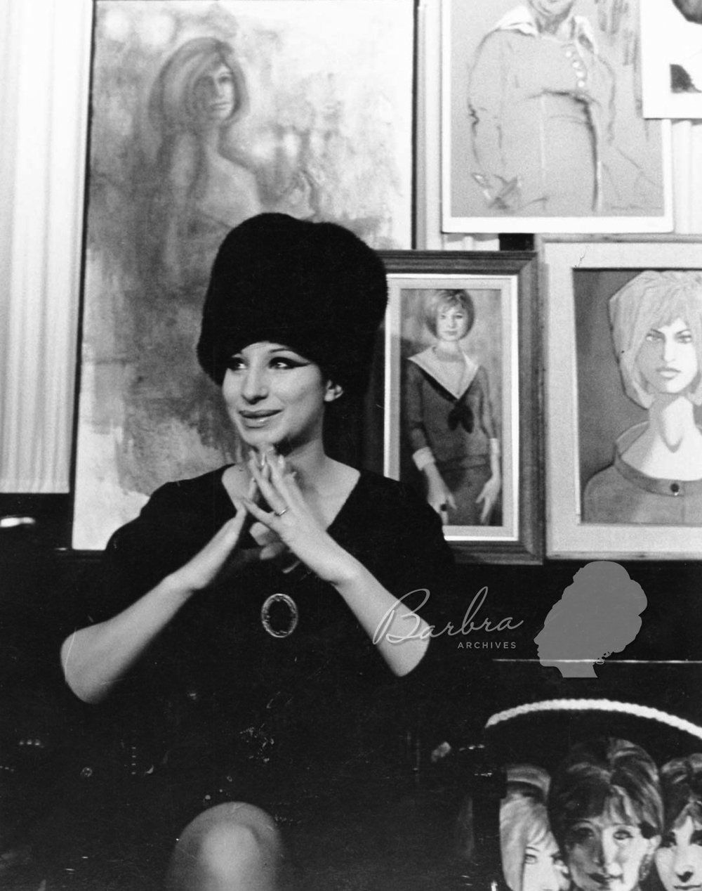 Streisand in dressing room, surrounded by fan art.