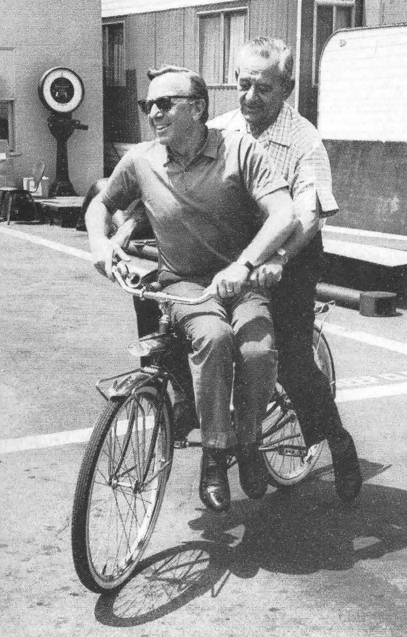 William Wyler and Ray Stark on a bike on the Columbia Pictures backlot.