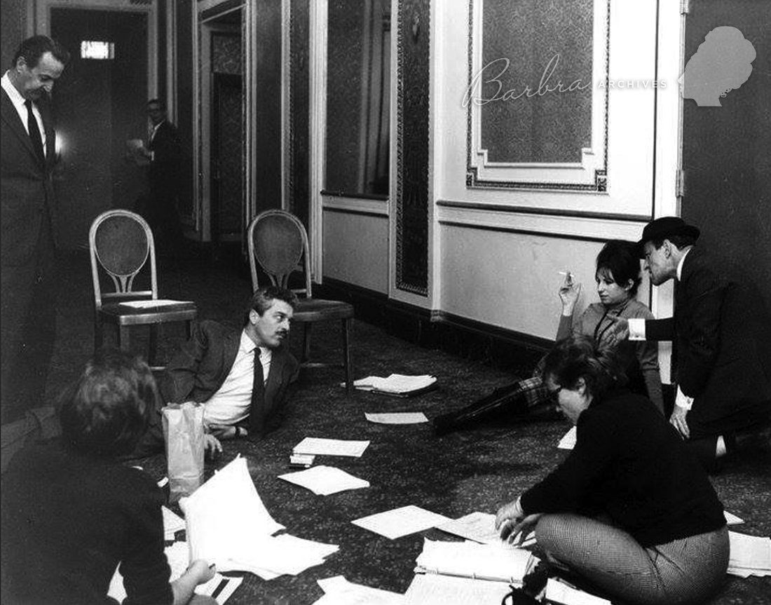 The creative crew of Funny Girl on the floor looking at the script.