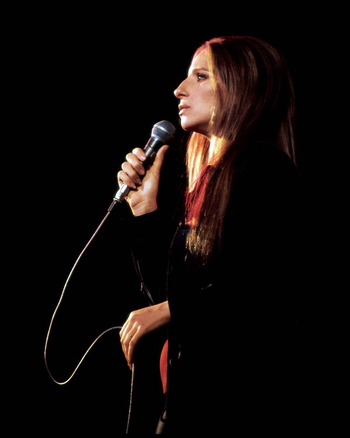 Barbra Streisand in profile, singing for McGovern at the Forum, 1972.