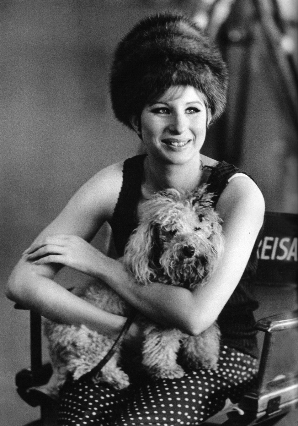 Barbra Streisand holds her dog, Sadie, on the set of Funny Girl.