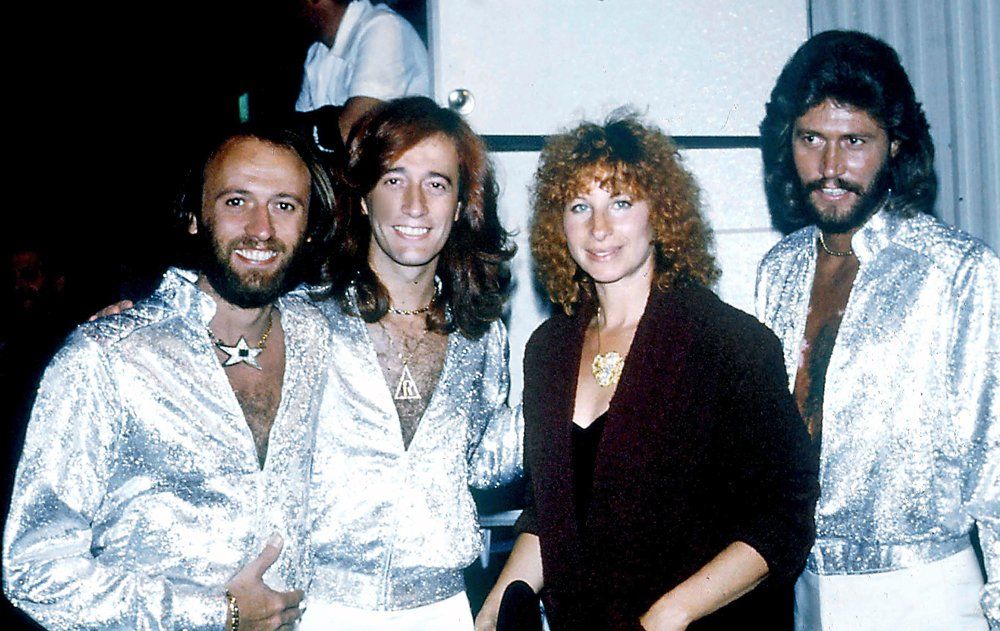Streisand poses with The Bee Gees at their concert. PHOTO: BOB SHERMAN