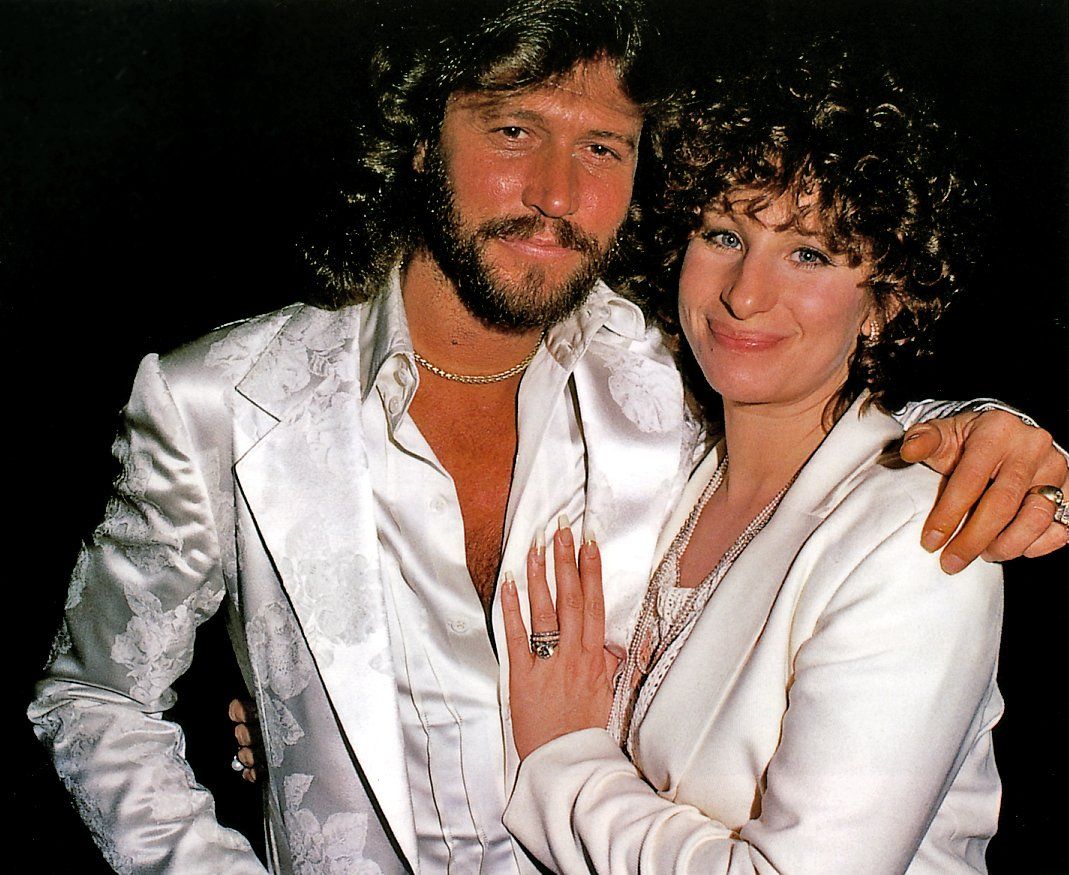 Casual pose by Barry Gibb and Barbra Streisand.