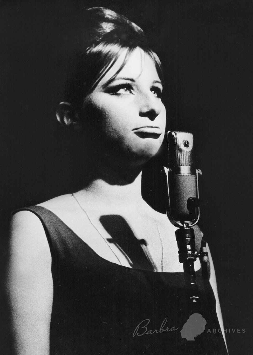 Photo of Barbra Streisand at the microphone at the hungry i.  Photo by Grover Sales.