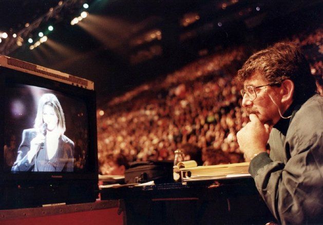 Gary Smith watches Barbra Streisand sing on a television monitor.