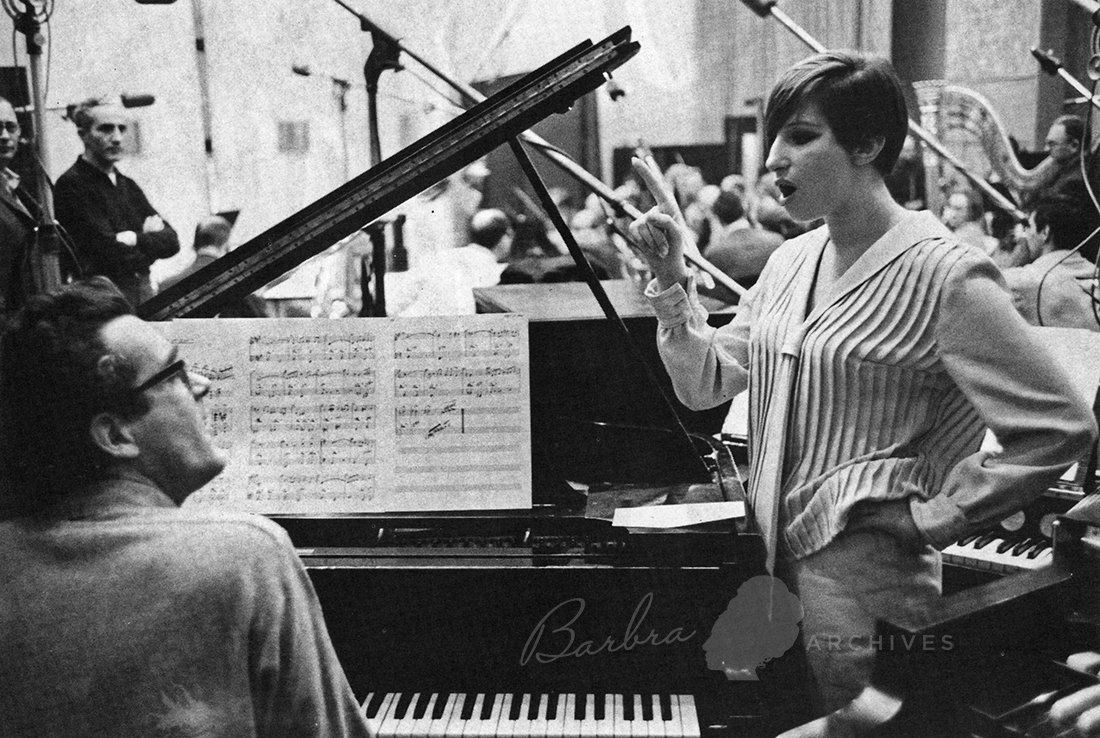 Michel Legrand at piano and Streisand beside him going over a song for the album